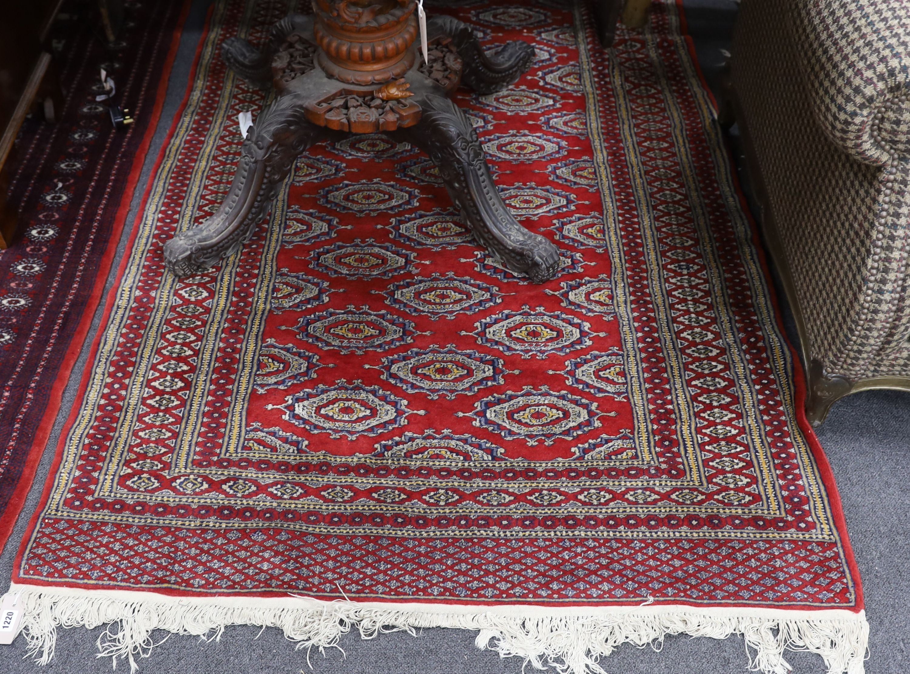 A Bokhara red ground rug, 196 x 126cm